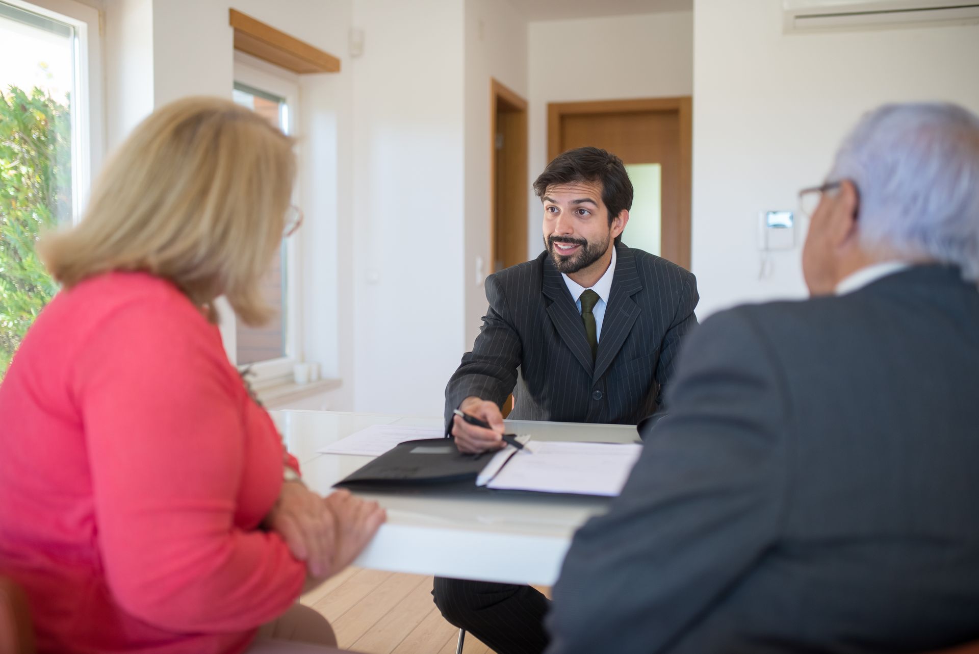 Asesor revisando documentos junto a un cliente